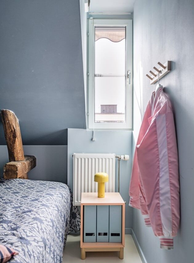 A Small, Colorful Attic Apartment with A Yellow Kitchen 21 tiny blue bedroom