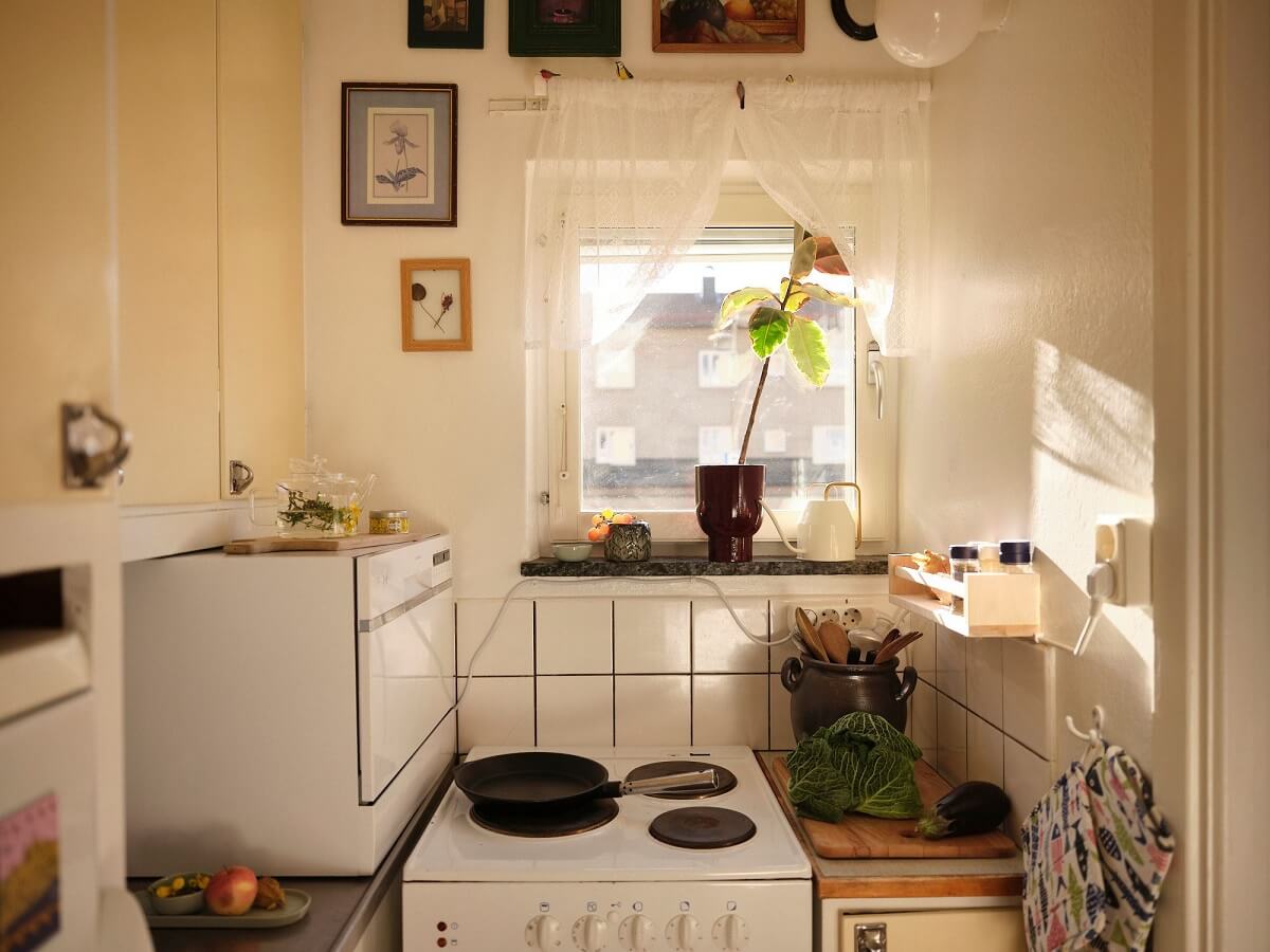 A Bold Pink Studio Apartment with a Light Yellow Kitchen 12 tiny butter yellow kitchen