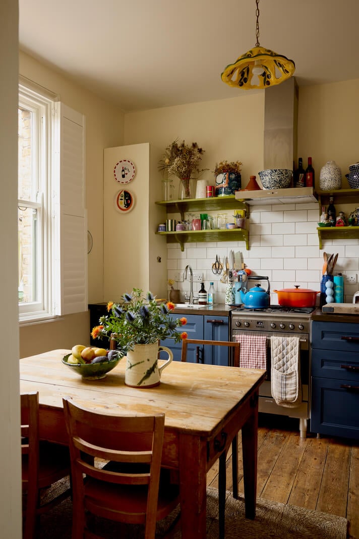 A Beautiful Color Palette in a Victorian London Apartment 6 tiny cottage style kitchen with blue cabinets and green shelves nordroom