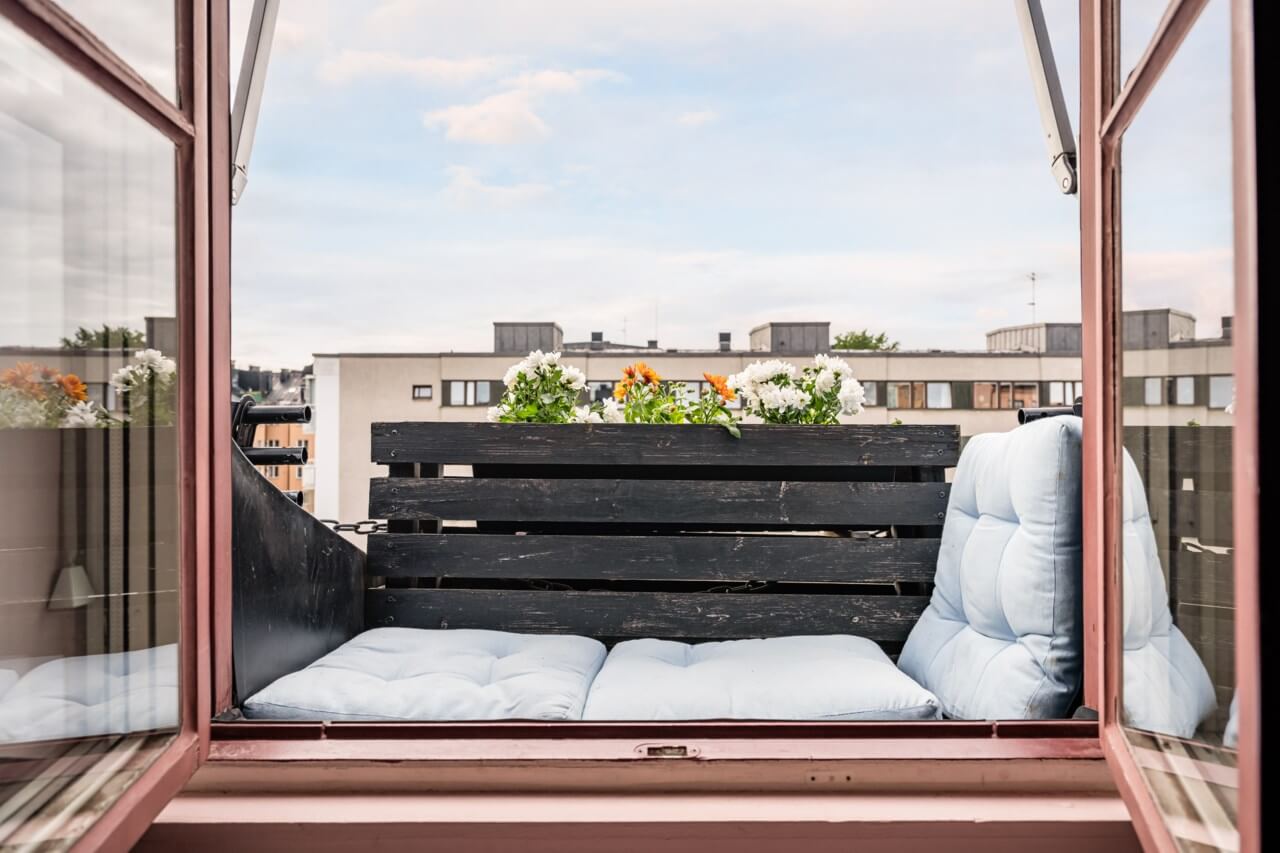 A Small, Colorful Attic Apartment with A Yellow Kitchen 9 tiny outdoor space