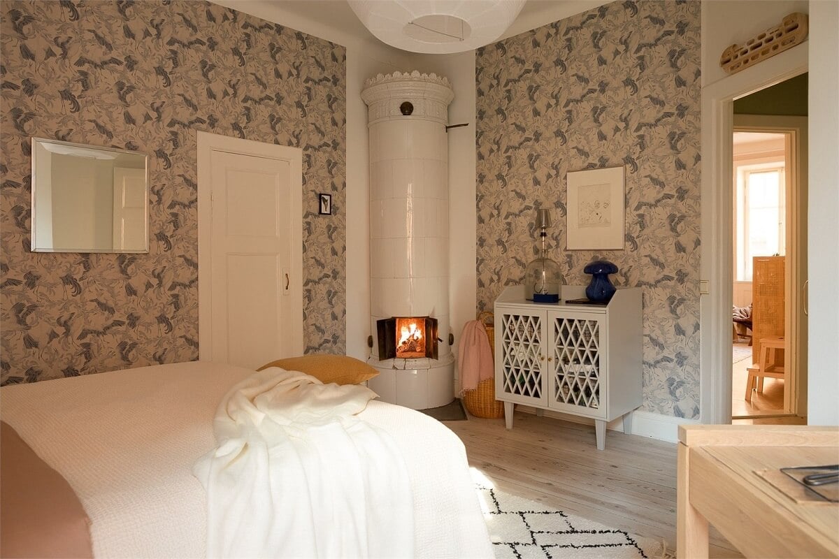 Nature-Inspired Colors in a Charming Stockholm Apartment 16 wallpapered bedroom with fireplace