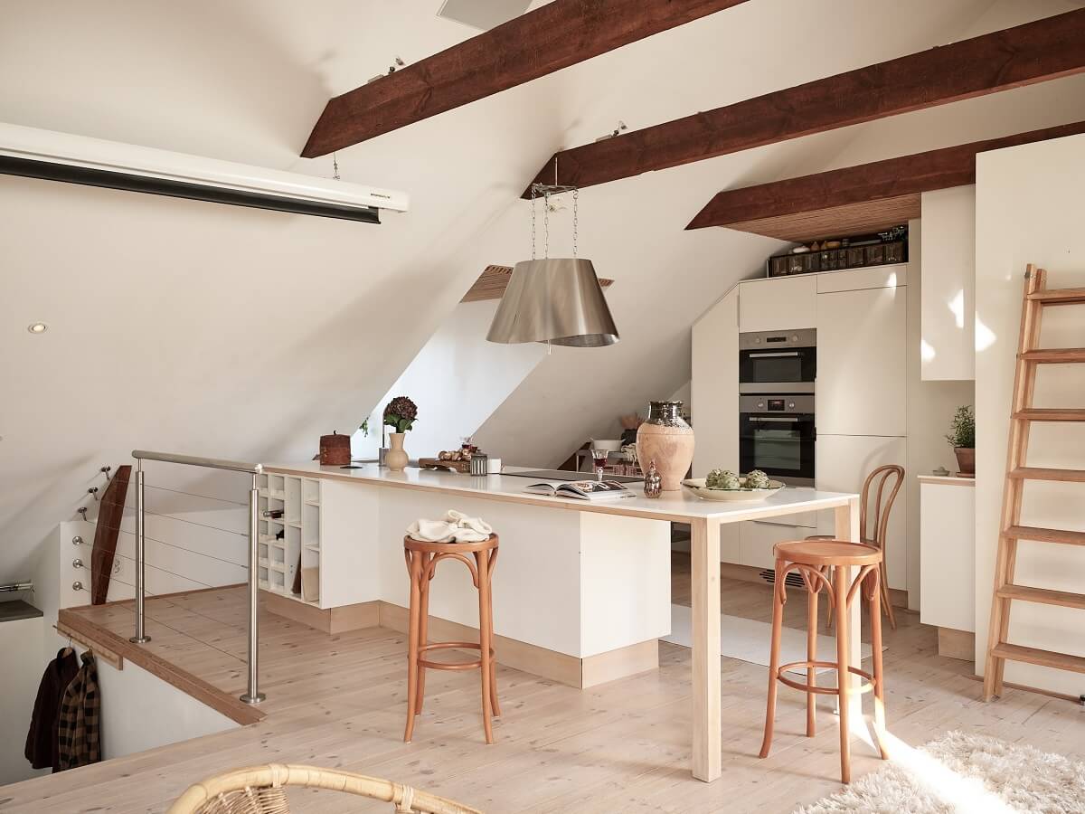 A Light Two-Bedroom Attic Apartment in Sweden 5 white kitchen ceiling beams