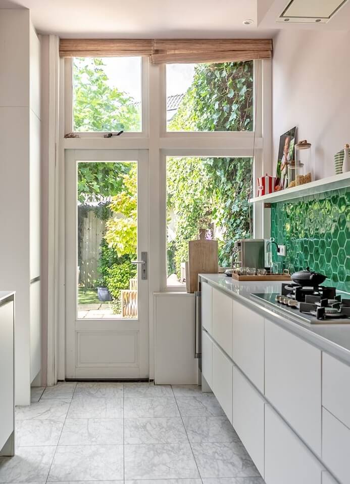 A Beautiful Monumental Villa with Green Color Accents 11 white kitchen with access to garden