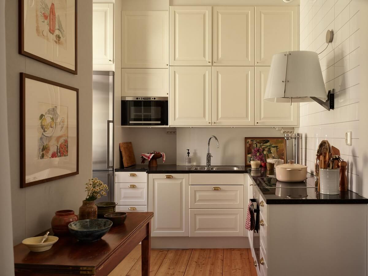 Period Features and Light Colors in a One-Bedroom Apartment 6 white kitchen with double upper cabinets