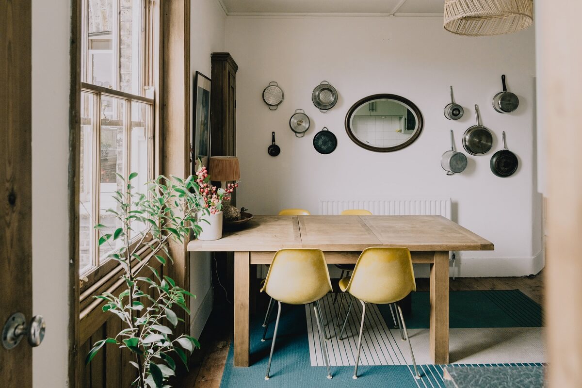 Period Details in a Cozy London Apartment in a Victorian Tenement Building 6 wooden dining table and blue rug
