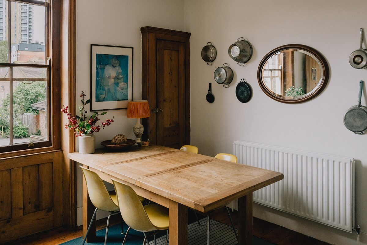 Period Details in a Cozy London Apartment in a Victorian Tenement Building 8 wooden dining table with yellow chairs