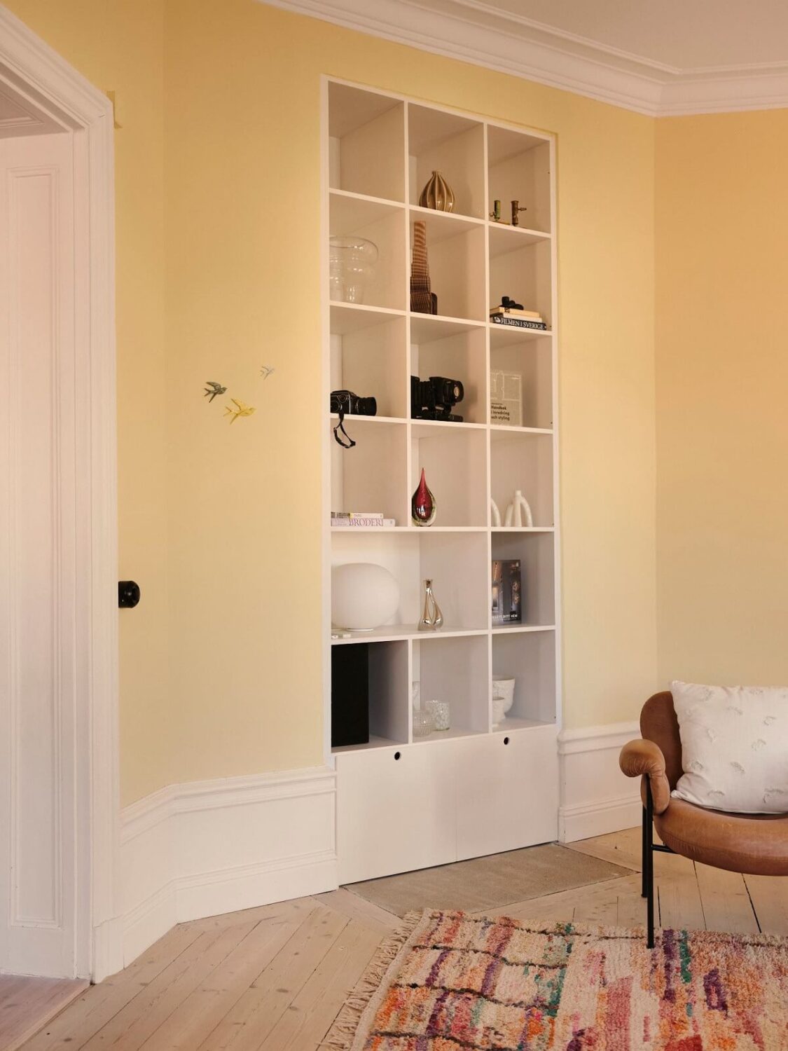 A Light Pastel Yellow and Pink Apartment in Stockholm 7 yellow living room built in bookcase