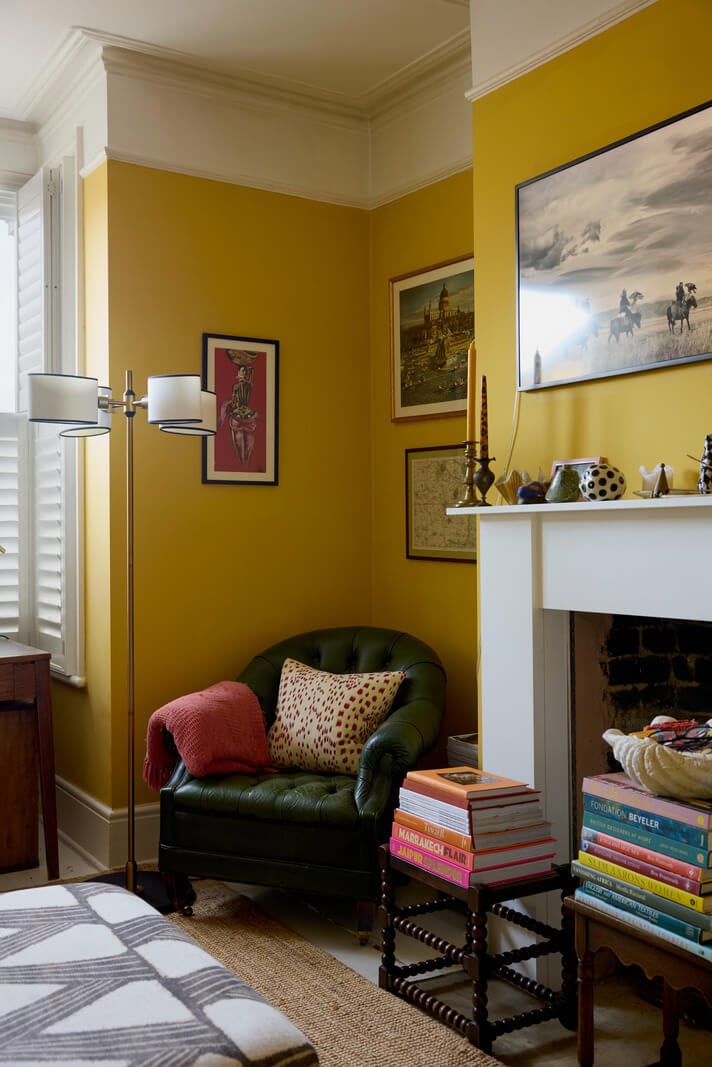 A Beautiful Color Palette in a Victorian London Apartment 2 yellow livoing room fireplace green armchair