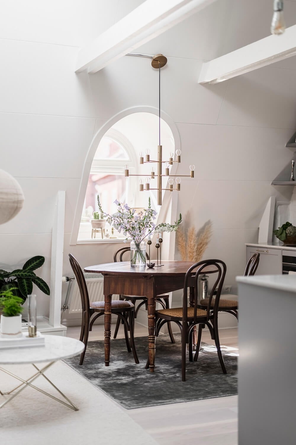 A Swedish Attic Apartment with a Lovely Balcony Overlooking the City 8 attic living room round wooden table