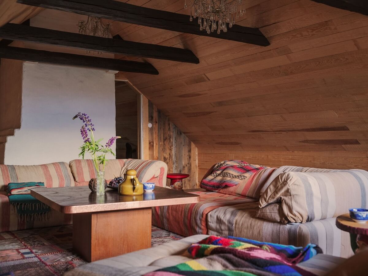 A Bohemian-Style House on the Estate of a Swedish Castle 23 attic sitting room wooden ceiling