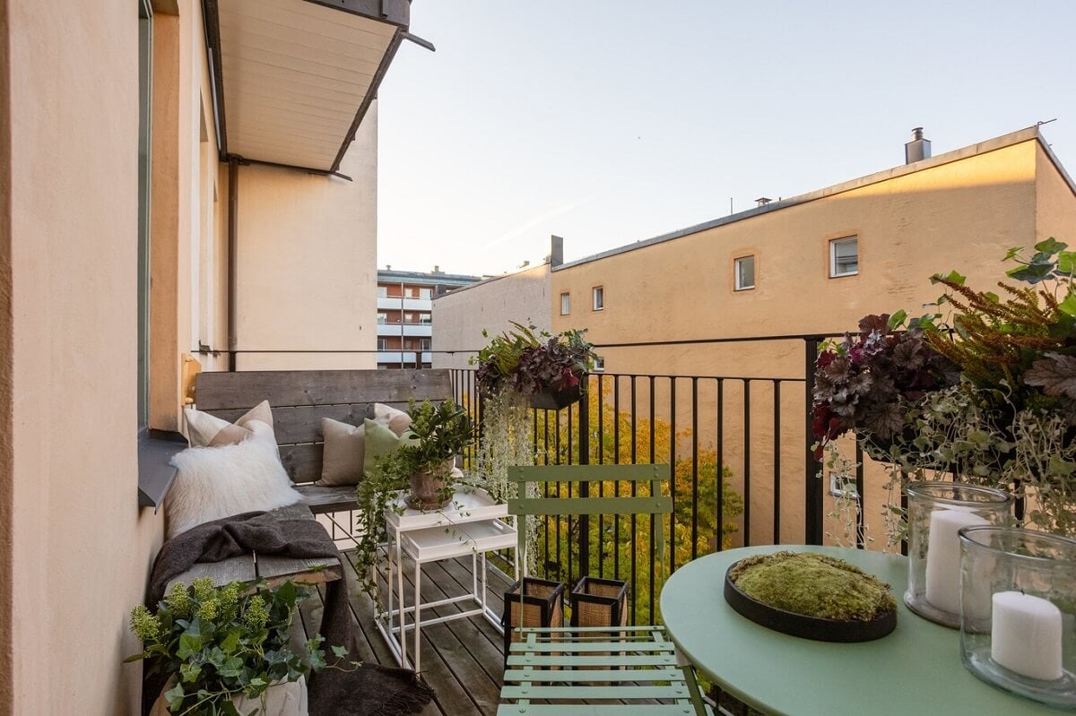 A Turn-of-the-Century Apartment with Warm Open-Plan Spaces 20 balcony with table and corner bench