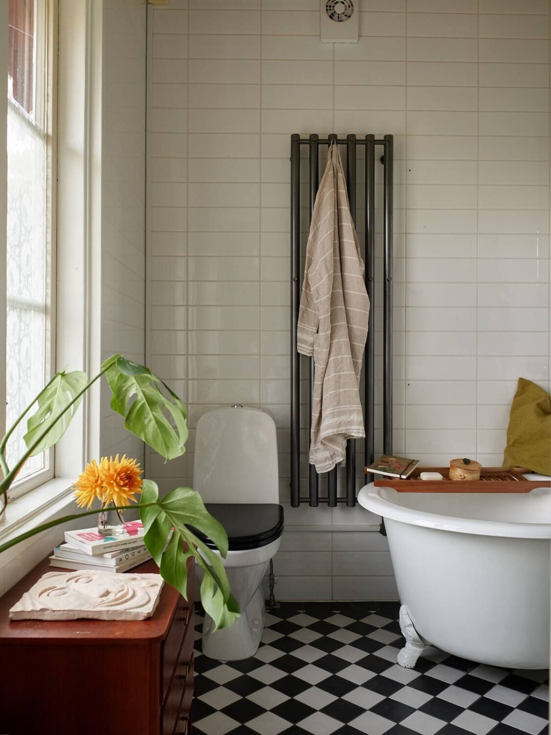 A Charming Swedish Cottage Filled with Art and Color 17 bathroom checkerboard floor and round rub