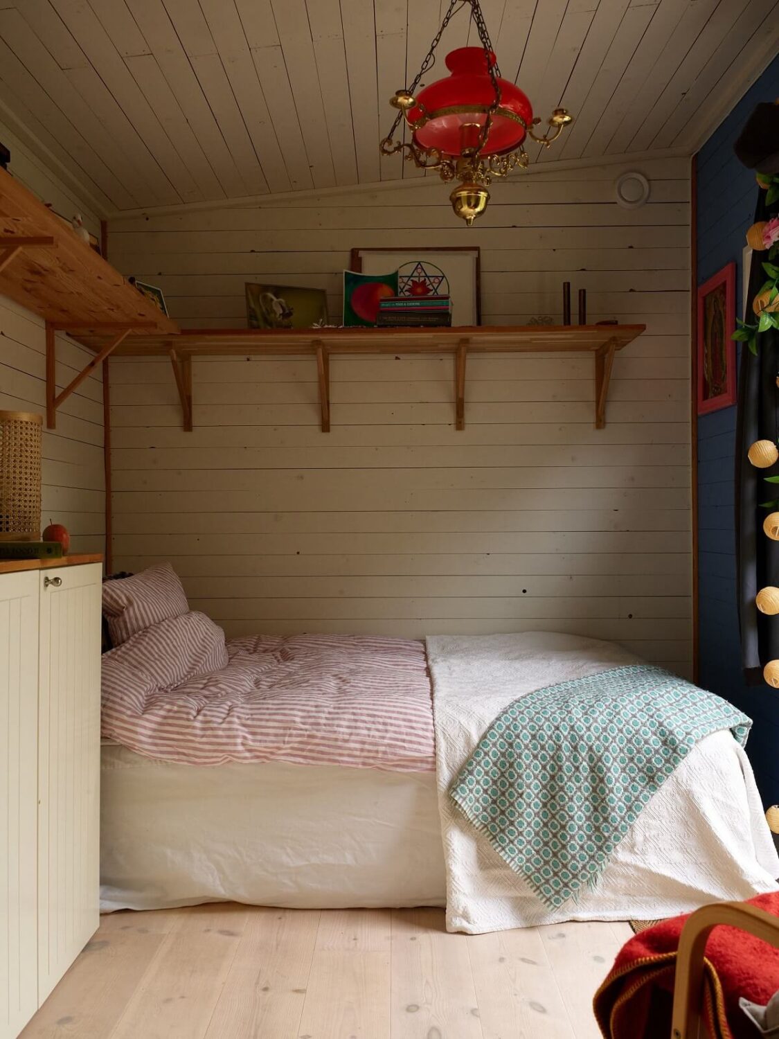 A Charming Swedish Cottage Filled with Art and Color 19 bedorom wooden walls shelf