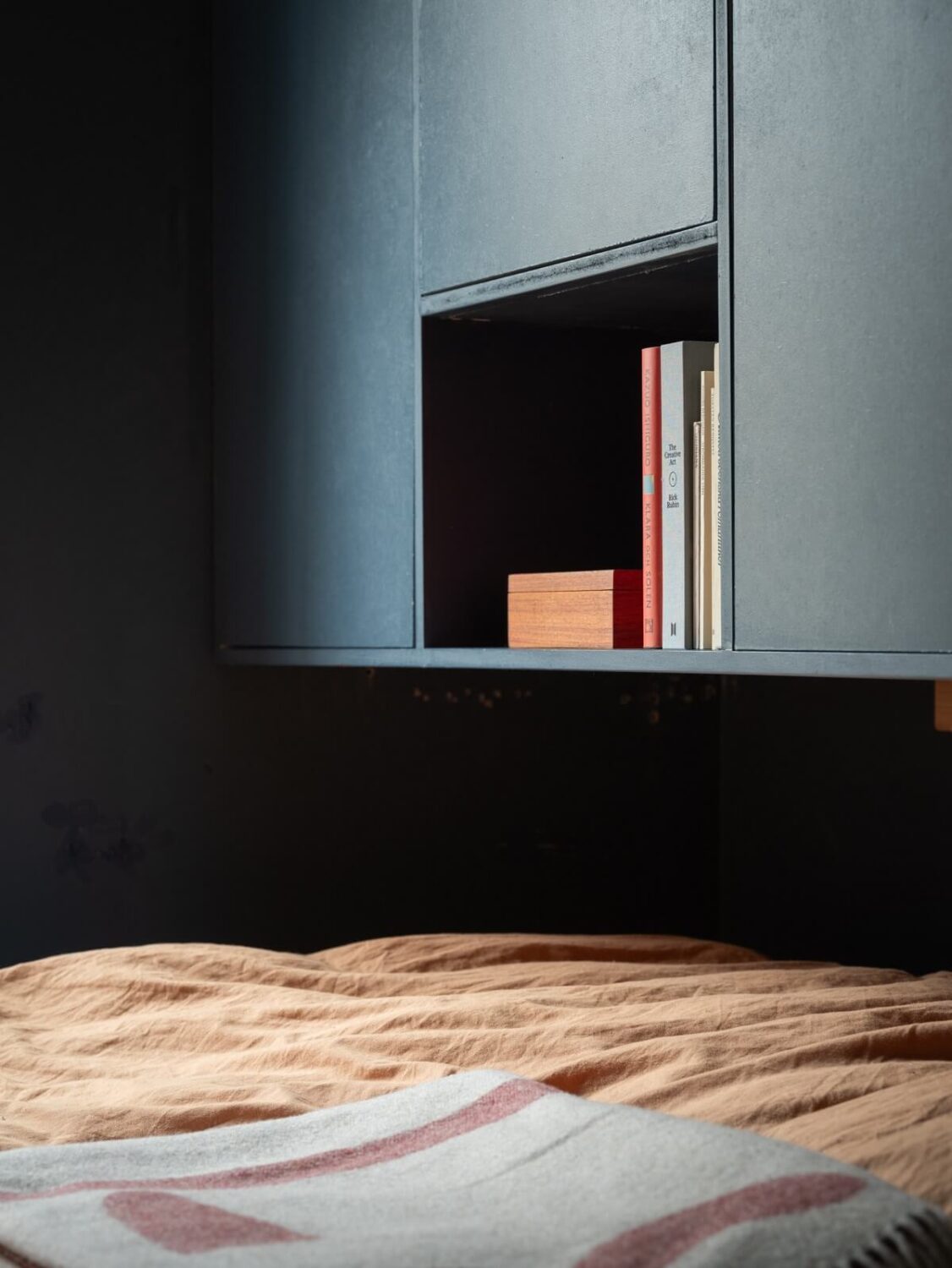 A Small Swedish Apartment with Dark Blue Walls 14 bedroom storage with open cabinet