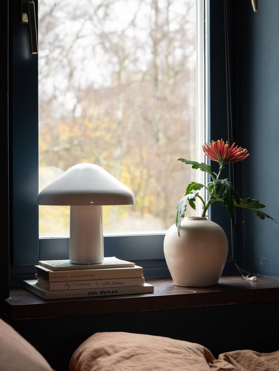 A Small Swedish Apartment with Dark Blue Walls 13 bedroom window sill