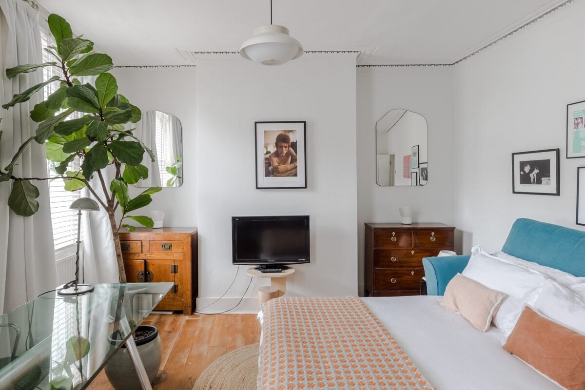 A Bright Extended and Renovated Victorian House in London 10 bedroom with blue headboard