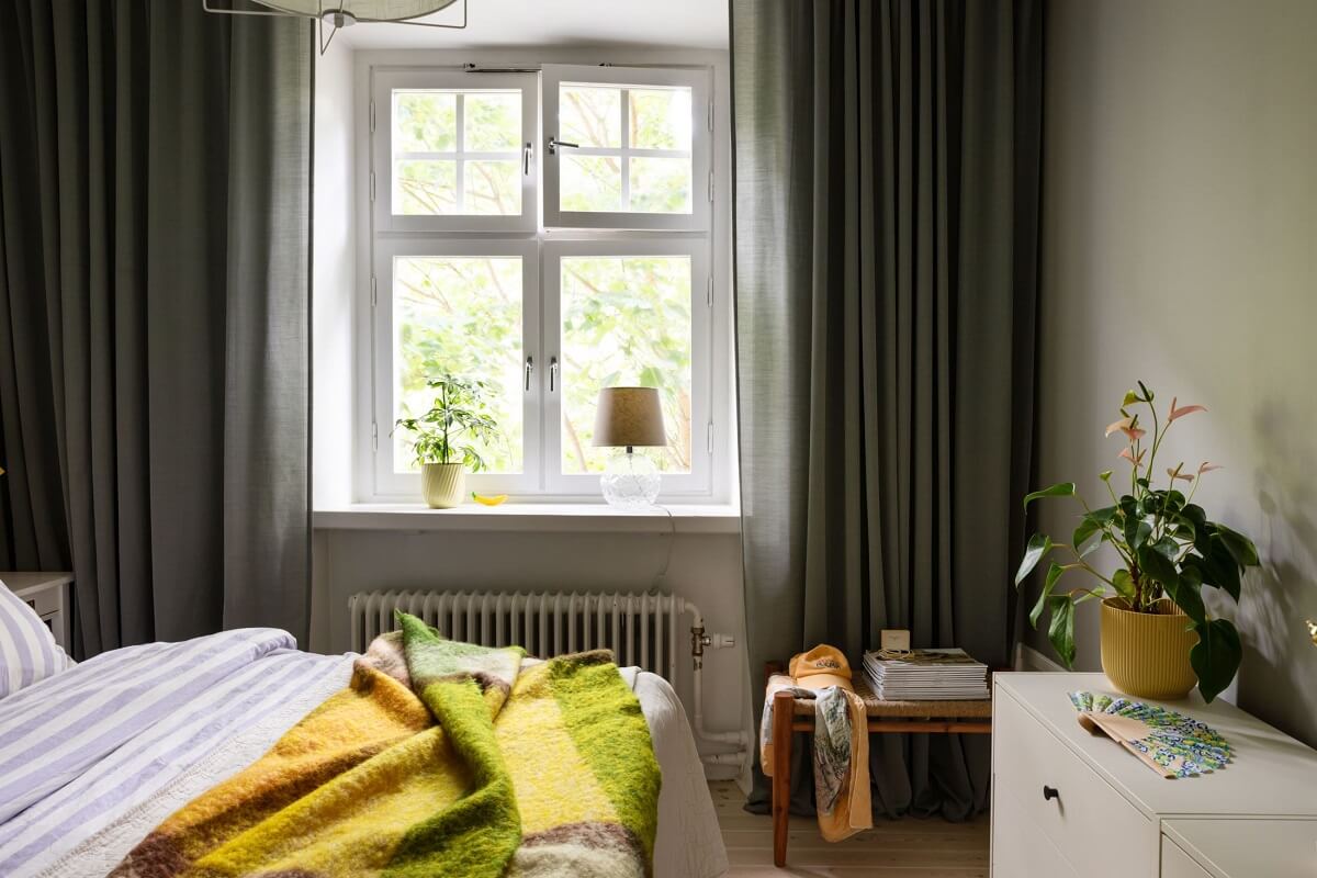 Soft Colors in a Charming Corner Apartment in Stockholm 9 bedroom with yellow and green throw