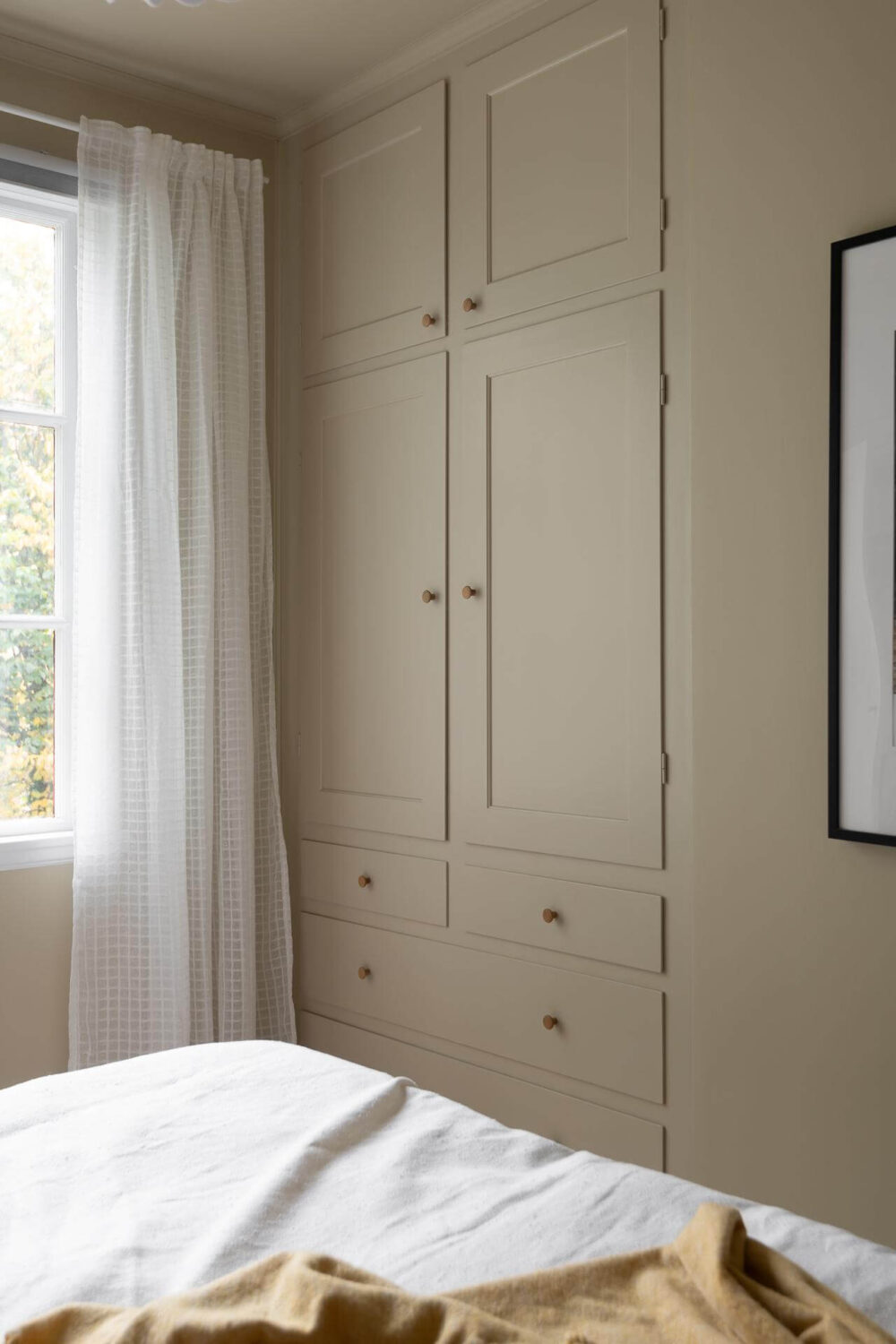 A Swedish Apartment Painted in Calm Beige, Green, and Pink Tones 19 beige bedroom built in closets
