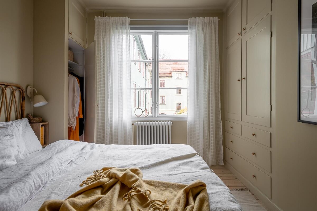A Swedish Apartment Painted in Calm Beige, Green, and Pink Tones 18 beige bedroom built in wardrobes