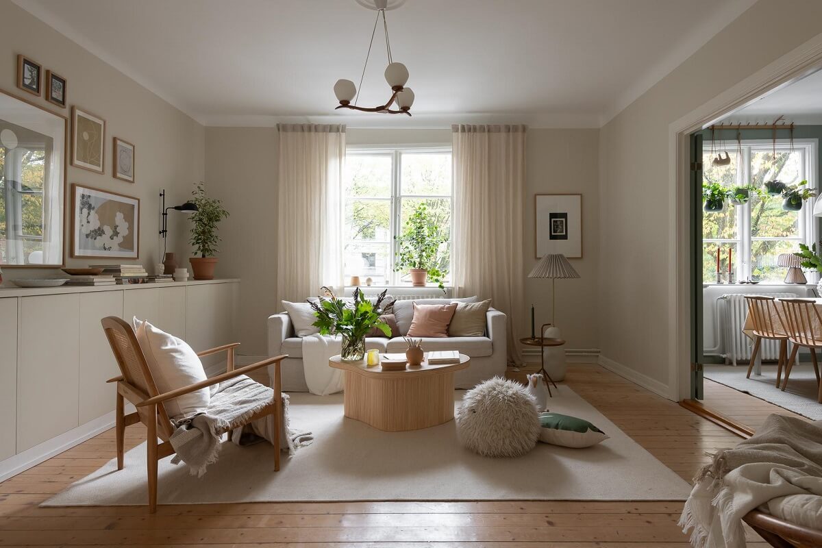 A Swedish Apartment Painted in Calm Beige, Green, and Pink Tones 2 beige living room with wooden floor and custom cabinets A Swedish Apartment Painted in Calm Beige, Green, and Pink Tones