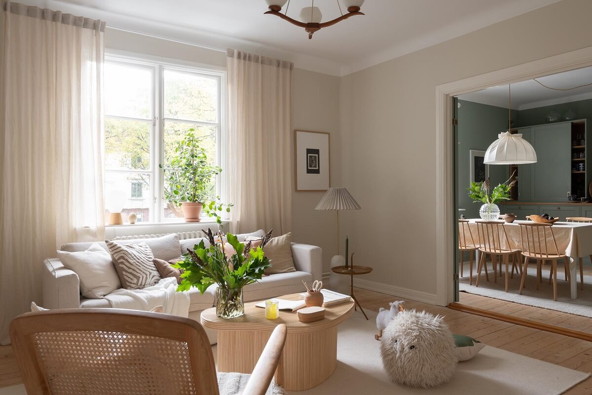 A Swedish Apartment Painted in Calm Beige, Green, and Pink Tones 3 beige scandi living room