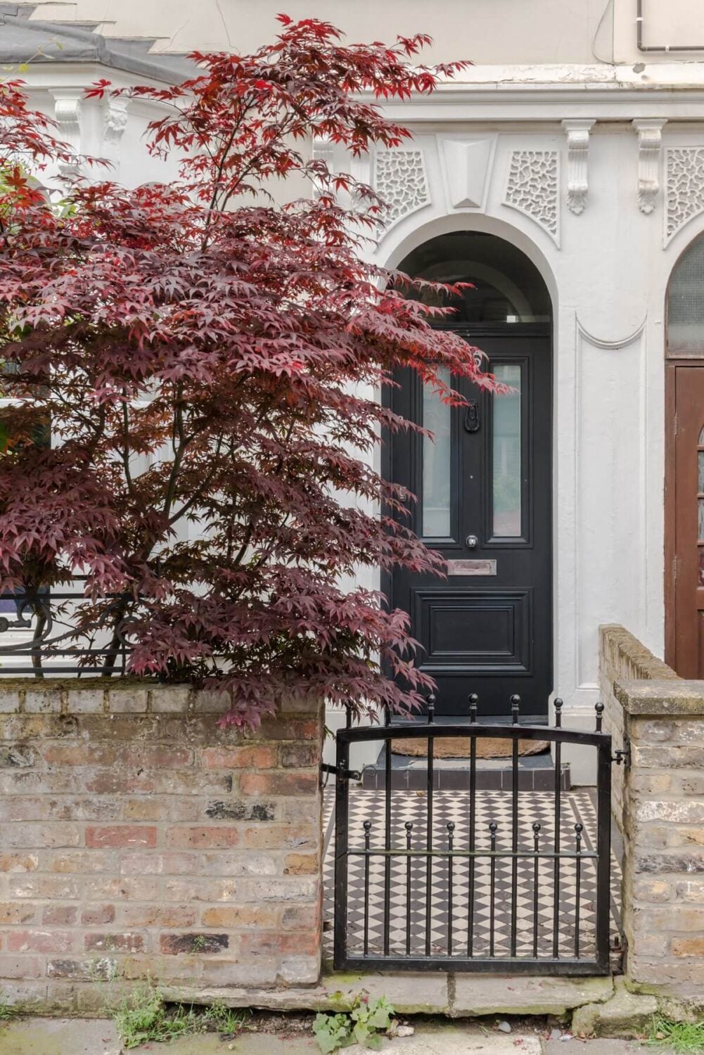 A Bright Extended and Renovated Victorian House in London 22 black front door with arched doorway