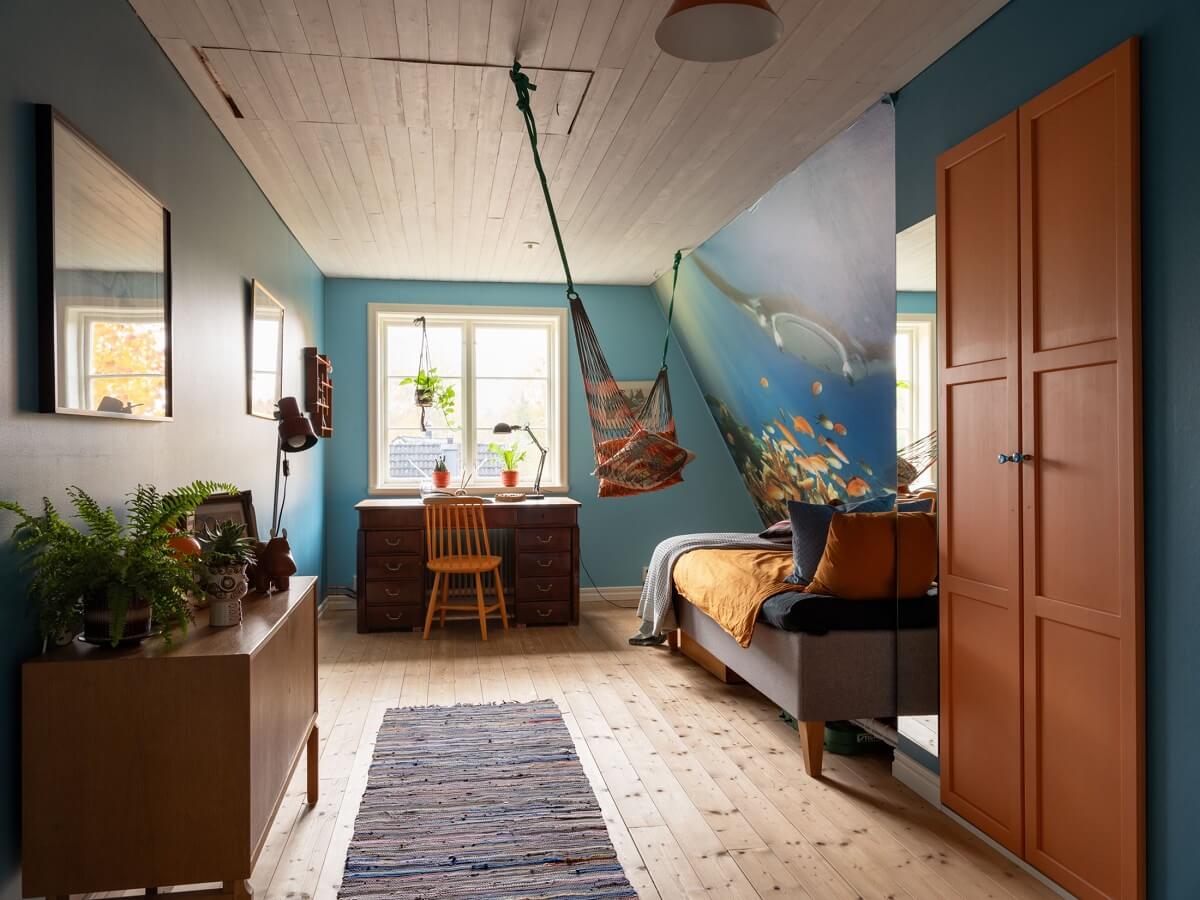 Best of 2024: Children's Bedrooms 19 blue bedroom with slanted ceiling built in orange wardrobes and hammock