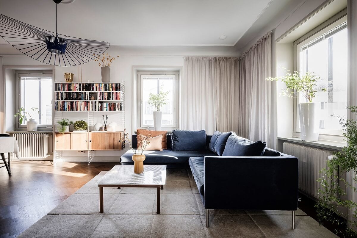 A Burgundy Kitchen in a Stylish Scandinavian Apartment 1 blue corner sofa scandi living room