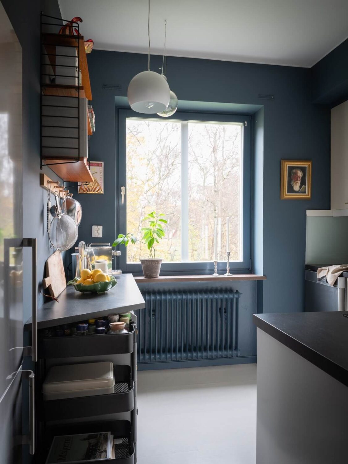 A Small Swedish Apartment with Dark Blue Walls 7 blue kitchen