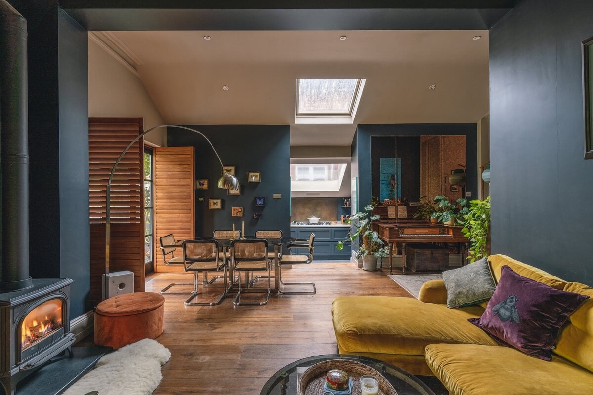 A Grand Ground Floor Apartment with Dark Blue Walls and a Garden 1 blue living room with wood burner ochre sofa and brown shutters nordroom
