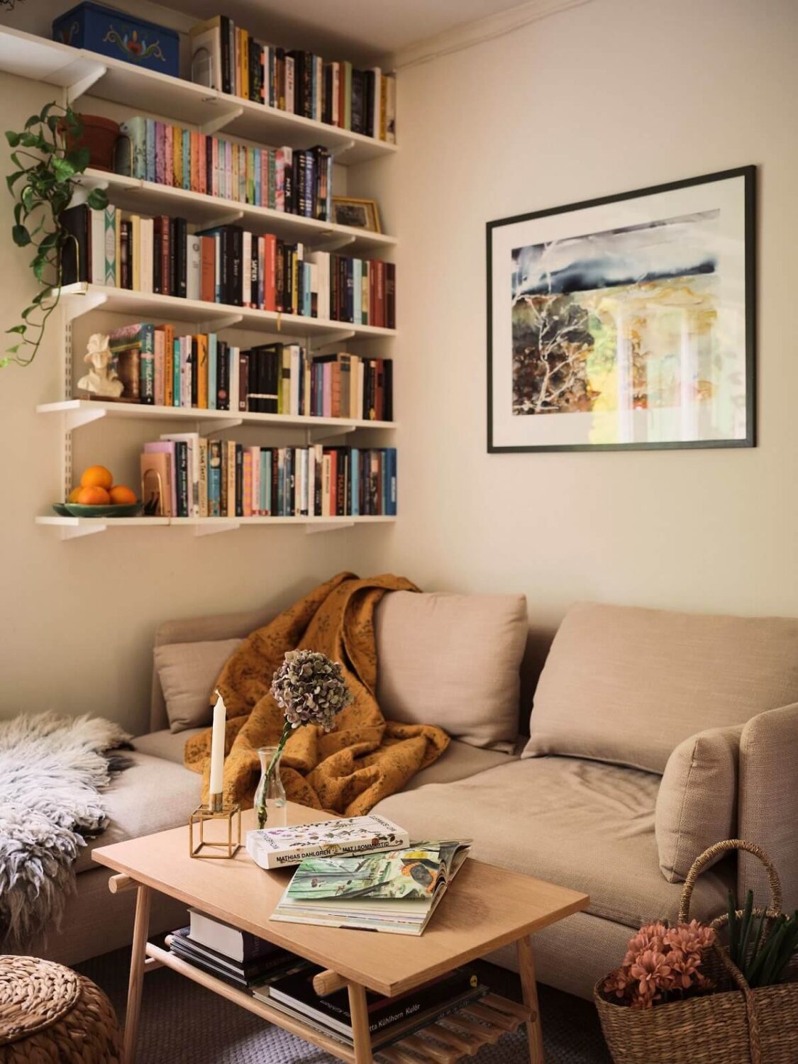 A Small Swedish Apartment with a Social and Semi-Open Floorplan 2 bookshelves in small neutral living room