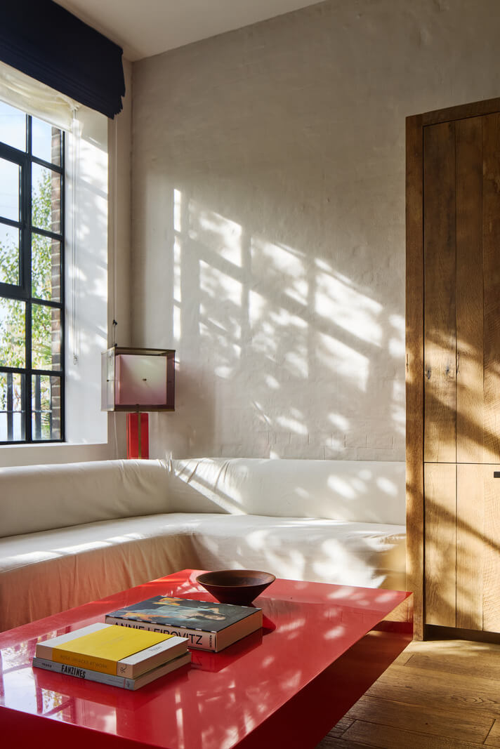 A Grand Industrial Warehouse Conversion in London 6 built in window seating red coffee table