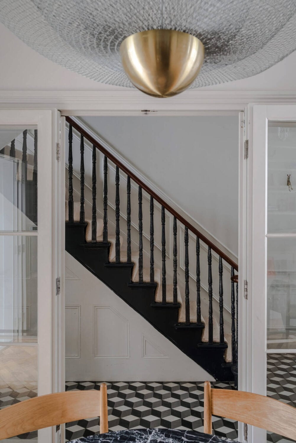 A Bright Extended and Renovated Victorian House in London 9 classic black and white tiles and black staircase