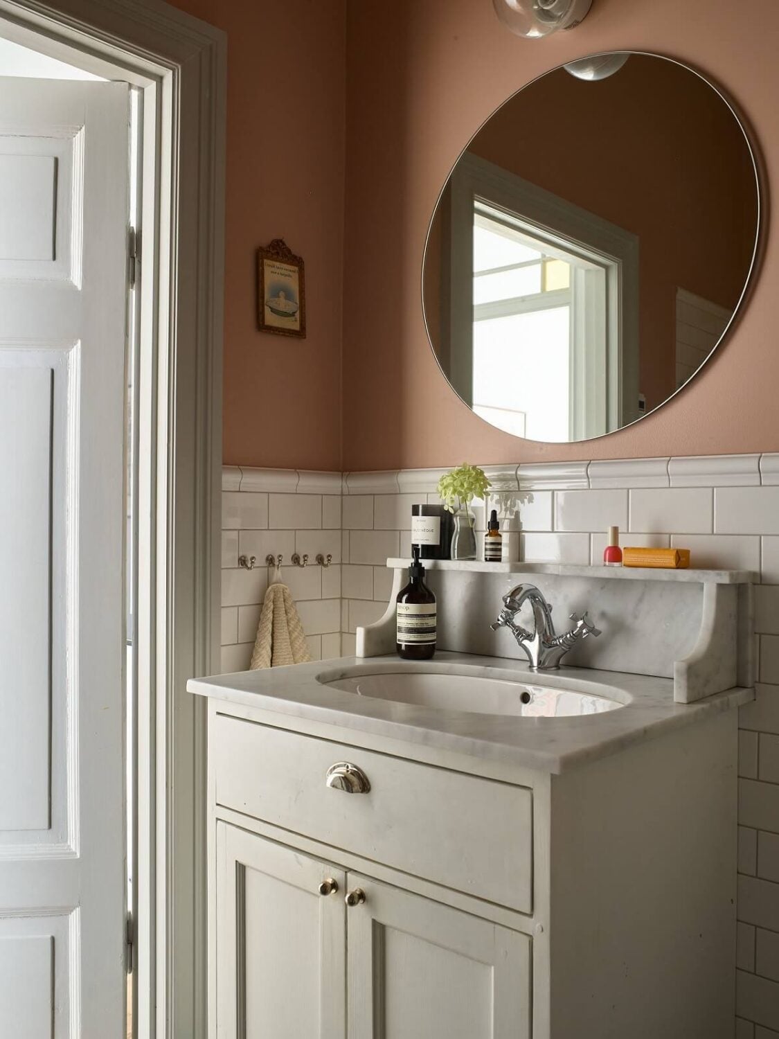 A Colorful Turn-of-the-Century Family Apartment in Stockholm 30 classic furniture round mirror pink bathroom
