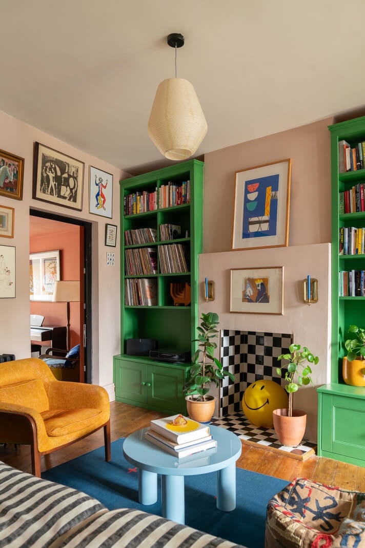 Colorful Rooms and Period Features in a London Terrace House 3 colorful living room striped sofa green built in bookcases