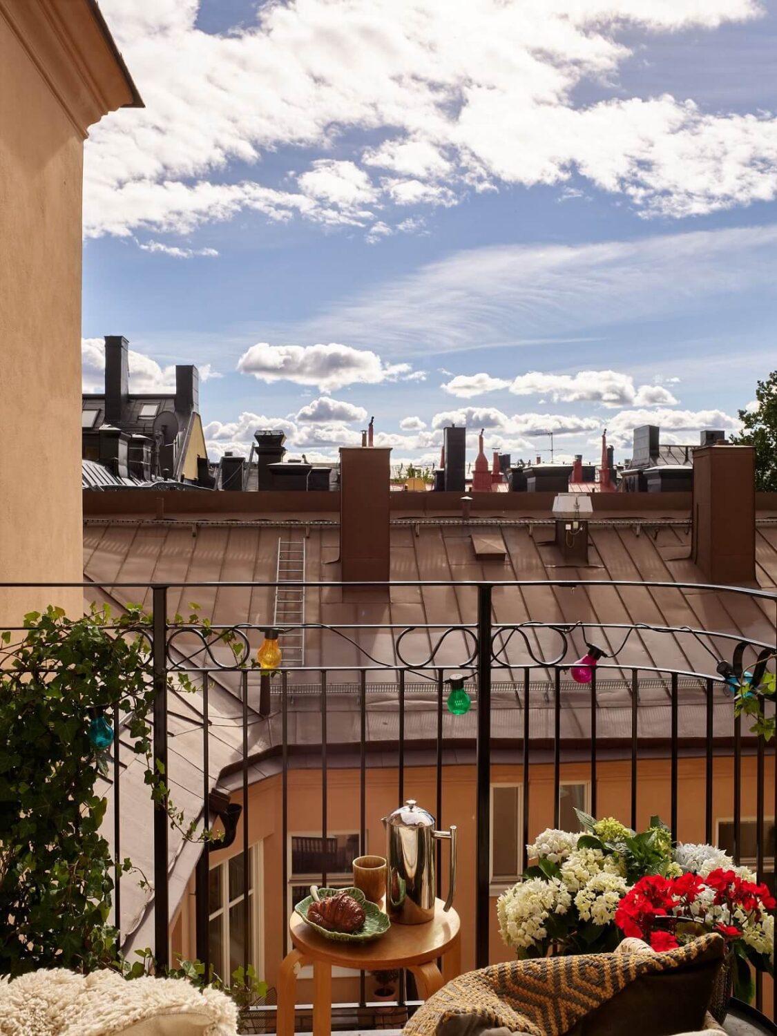 A Colorful Turn-of-the-Century Family Apartment in Stockholm 27 colorful string lights balcony rooftop view