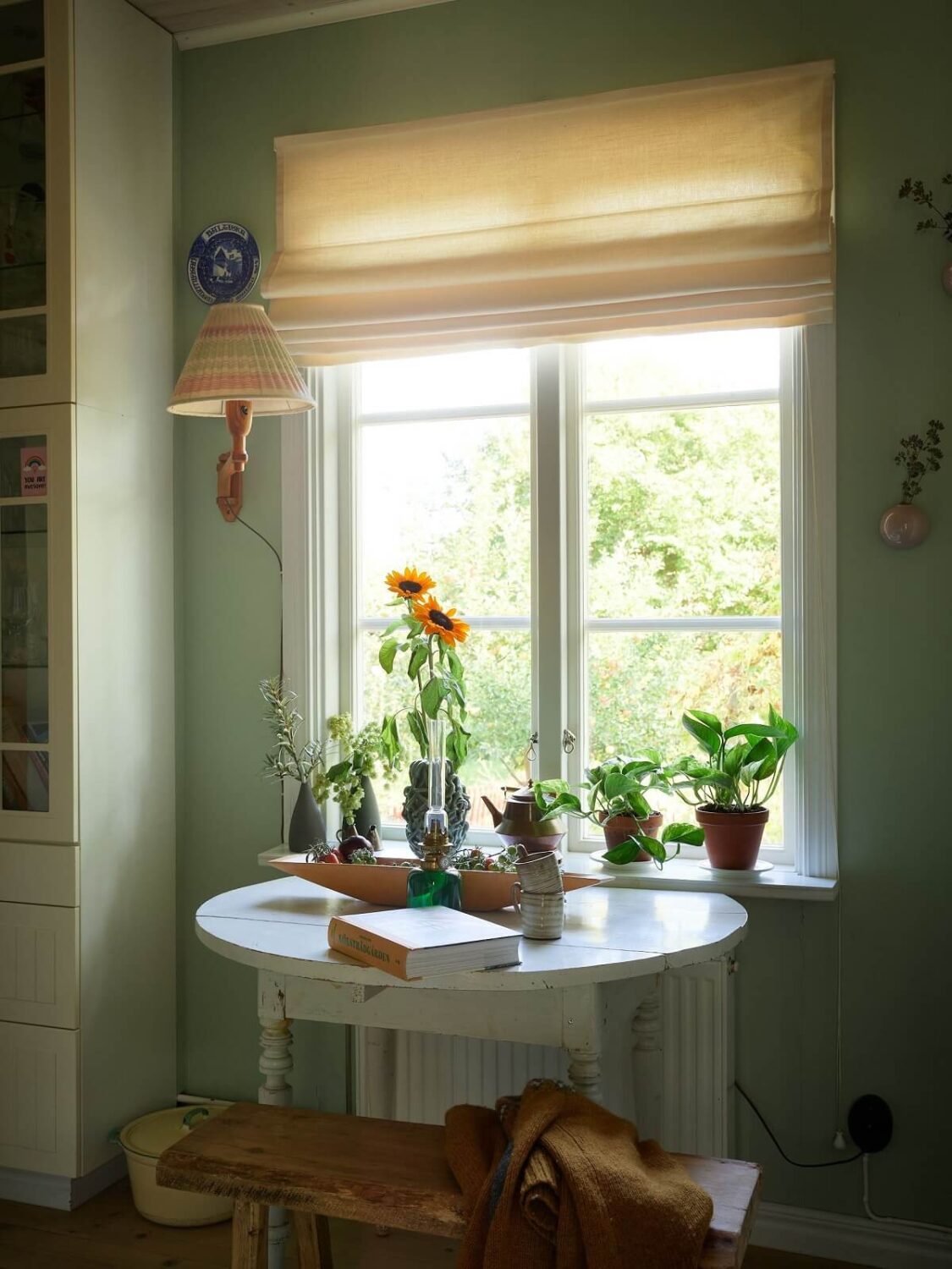 A Charming Swedish Cottage Filled with Art and Color 10 cottage kitchen table