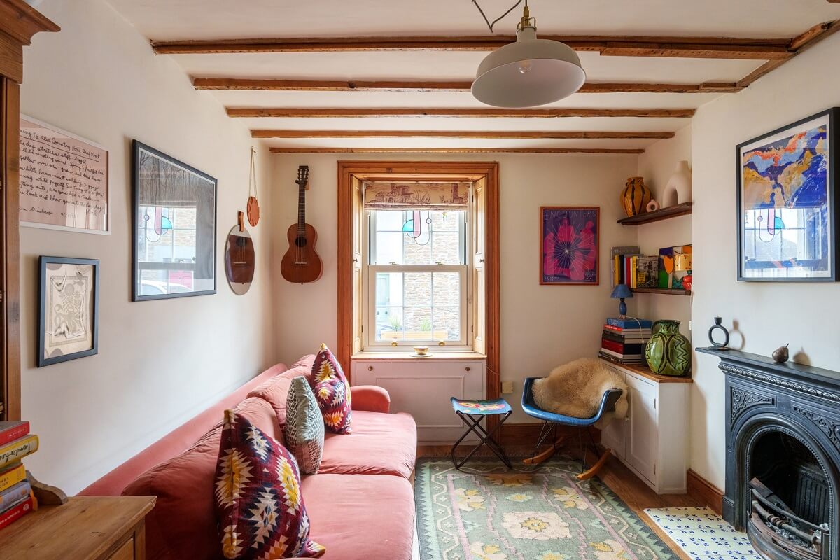 Colorful Furniture in a Historic English Cottage 1 cottage living room with pink couch fireplace and exposed beams