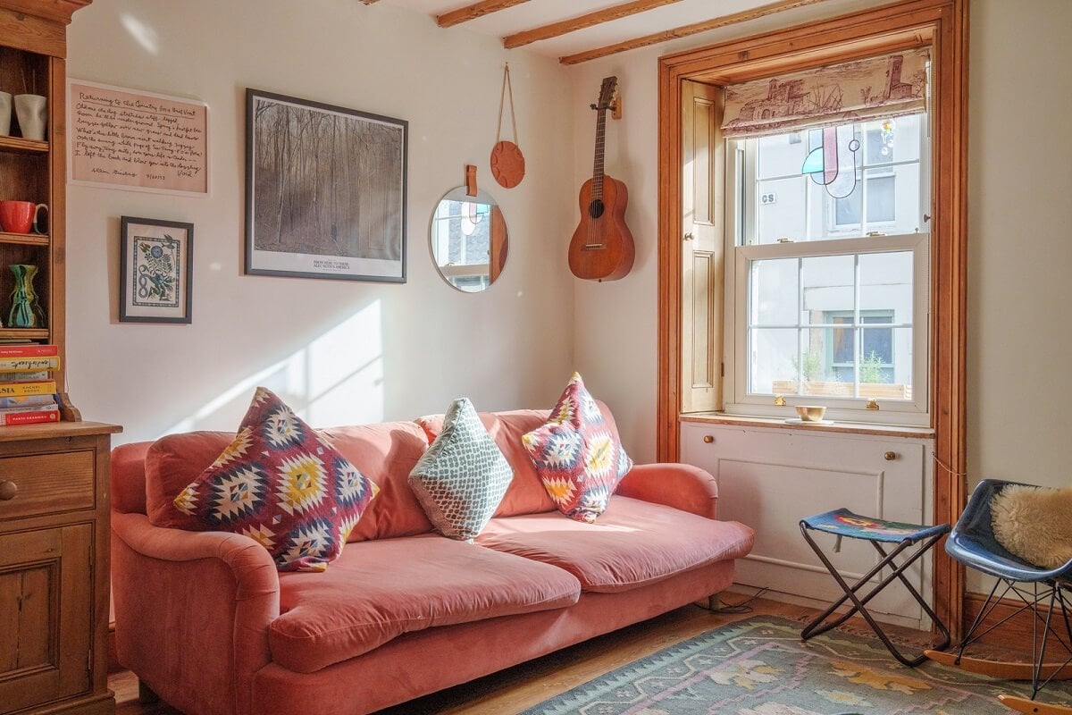 Colorful Furniture in a Historic English Cottage 2 cottage living room with pink couch