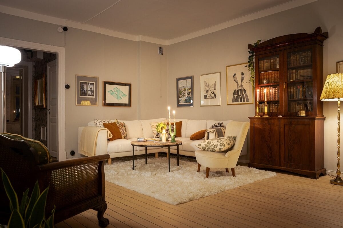 A Stately Apartment with Period Details and Wallpapers 9 cozy living room with ligh gray walls wooden floor and corner sofa