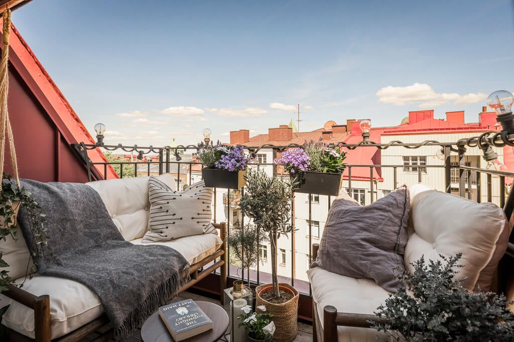 A Swedish Attic Apartment with a Lovely Balcony Overlooking the City 14 cozy seating balcony
