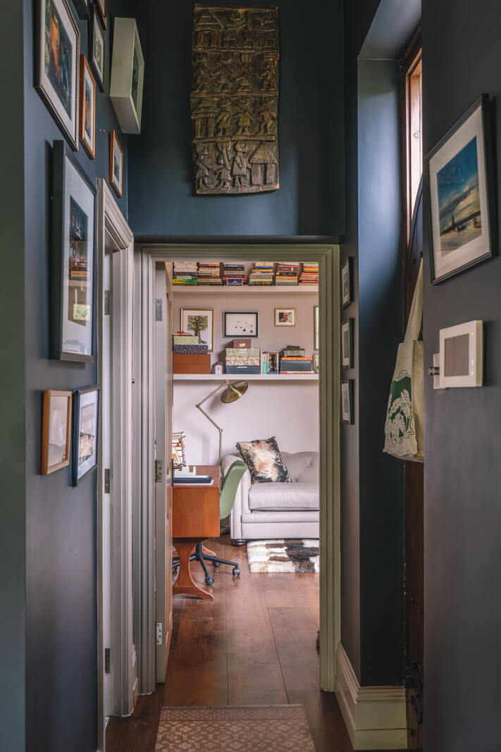 A Grand Ground Floor Apartment with Dark Blue Walls and a Garden 17 dark blue hallway with art