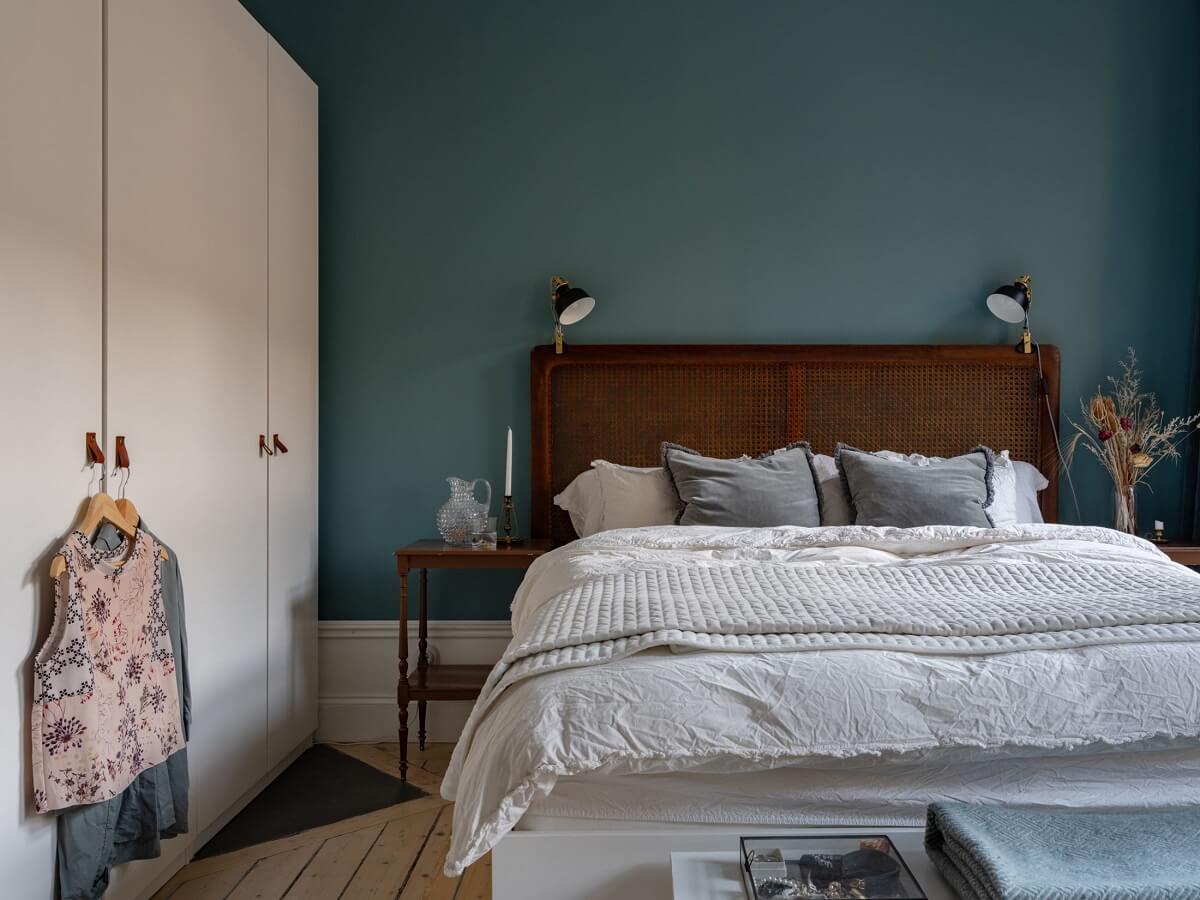 An 1890s Stockholm Apartment with a Blue Bedroom 9 dark cane headboard blue bedroom
