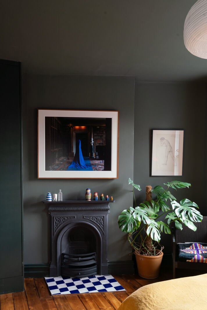Colorful Rooms and Period Features in a London Terrace House 13 dark gray bedroom with fireplace and checkerboard tiles