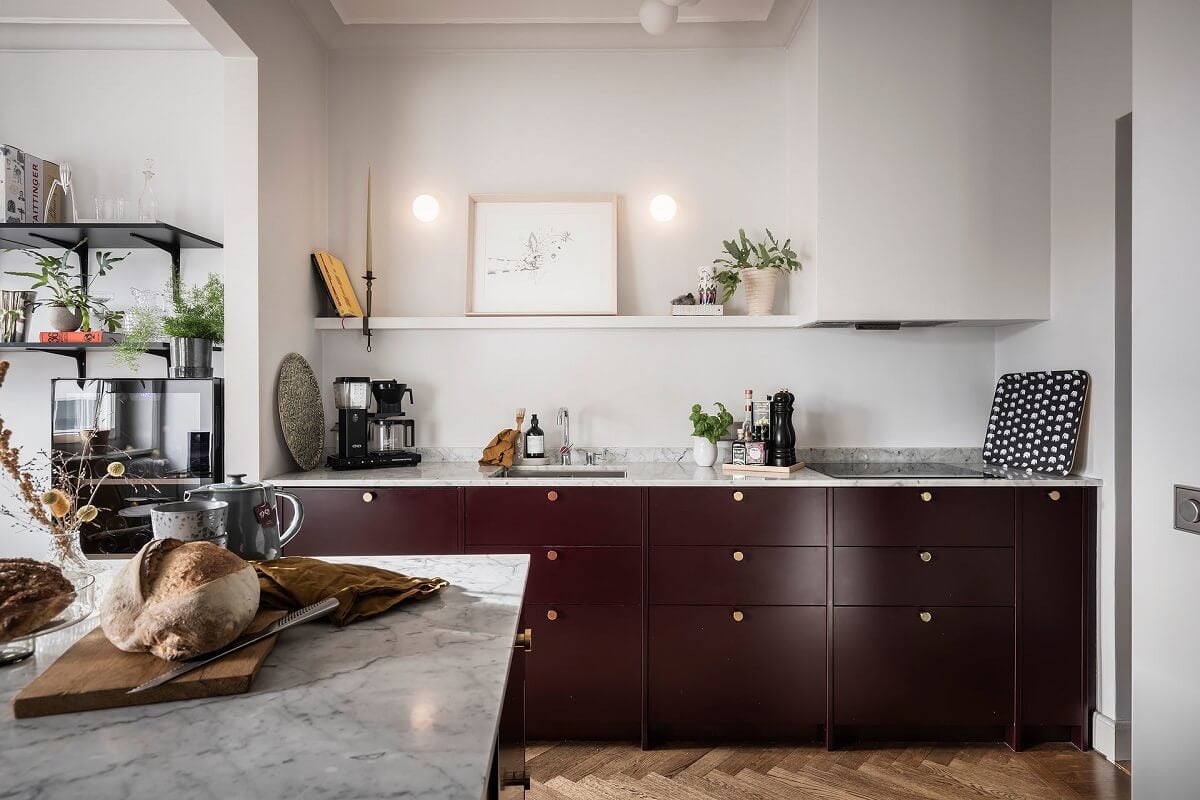 A Burgundy Kitchen in a Stylish Scandinavian Apartment 13 dark pink kitchen cabinets wooden floor