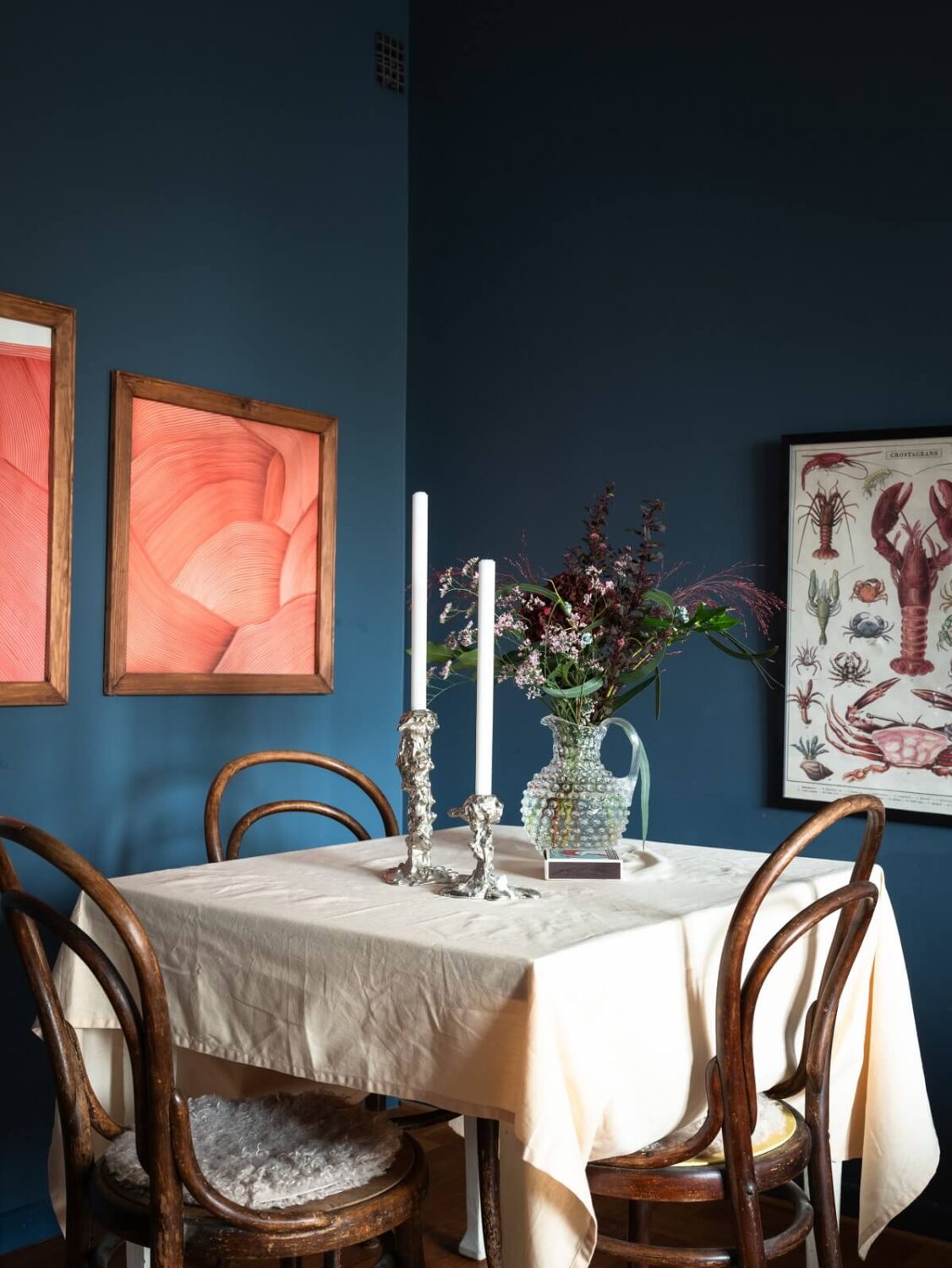 A Small Swedish Apartment with Dark Blue Walls 6 deep blue living room square dining table vintage chairs
