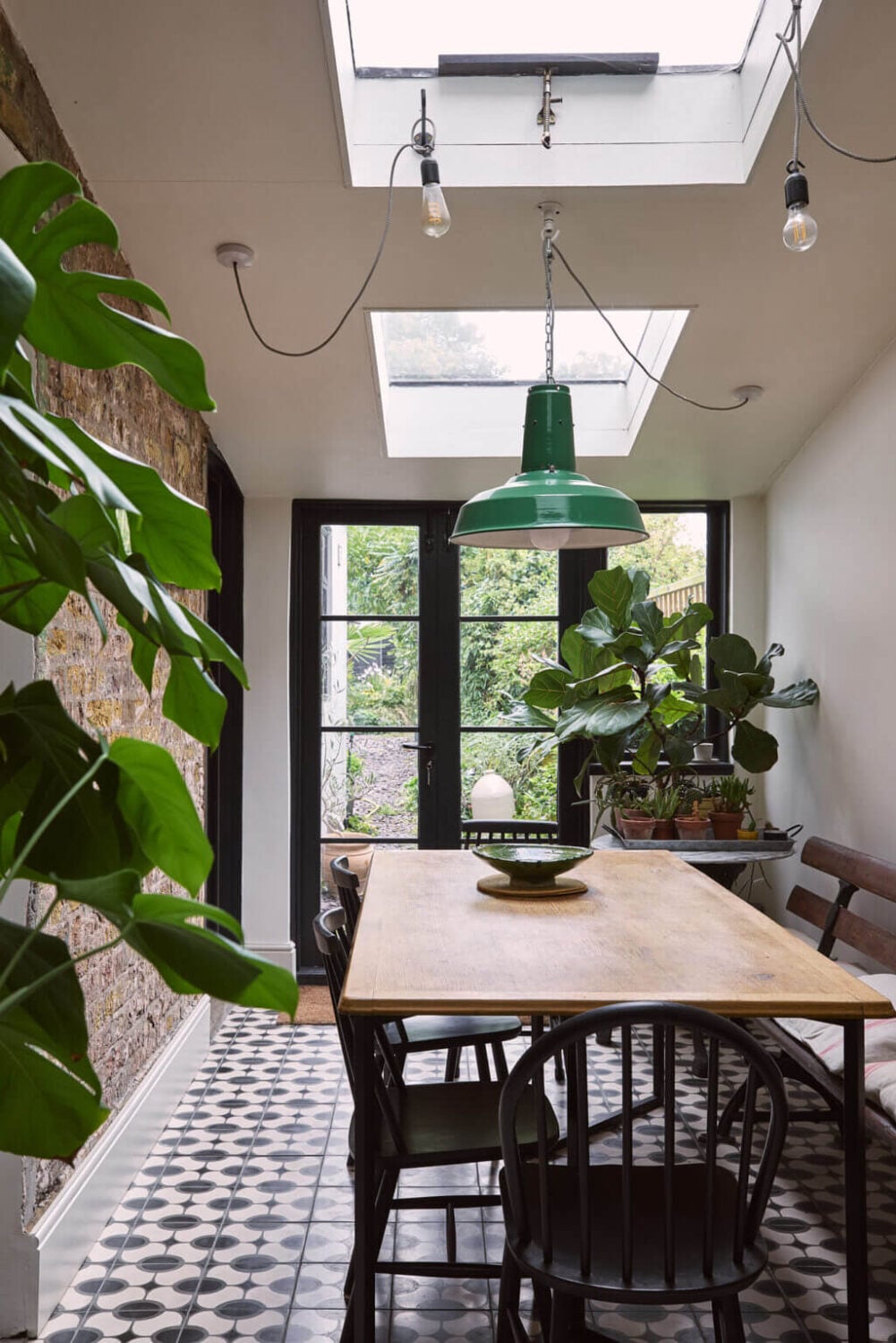 A Grand Victorian House with Many Period Features and a Lush Garden 8 dining room with tiled floor green pendant skylights and brick wall