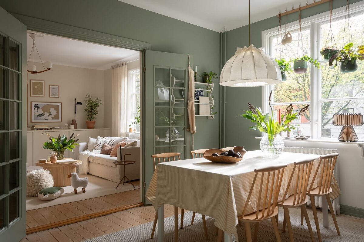 A Swedish Apartment Painted in Calm Beige, Green, and Pink Tones 16 dining table green kitchen