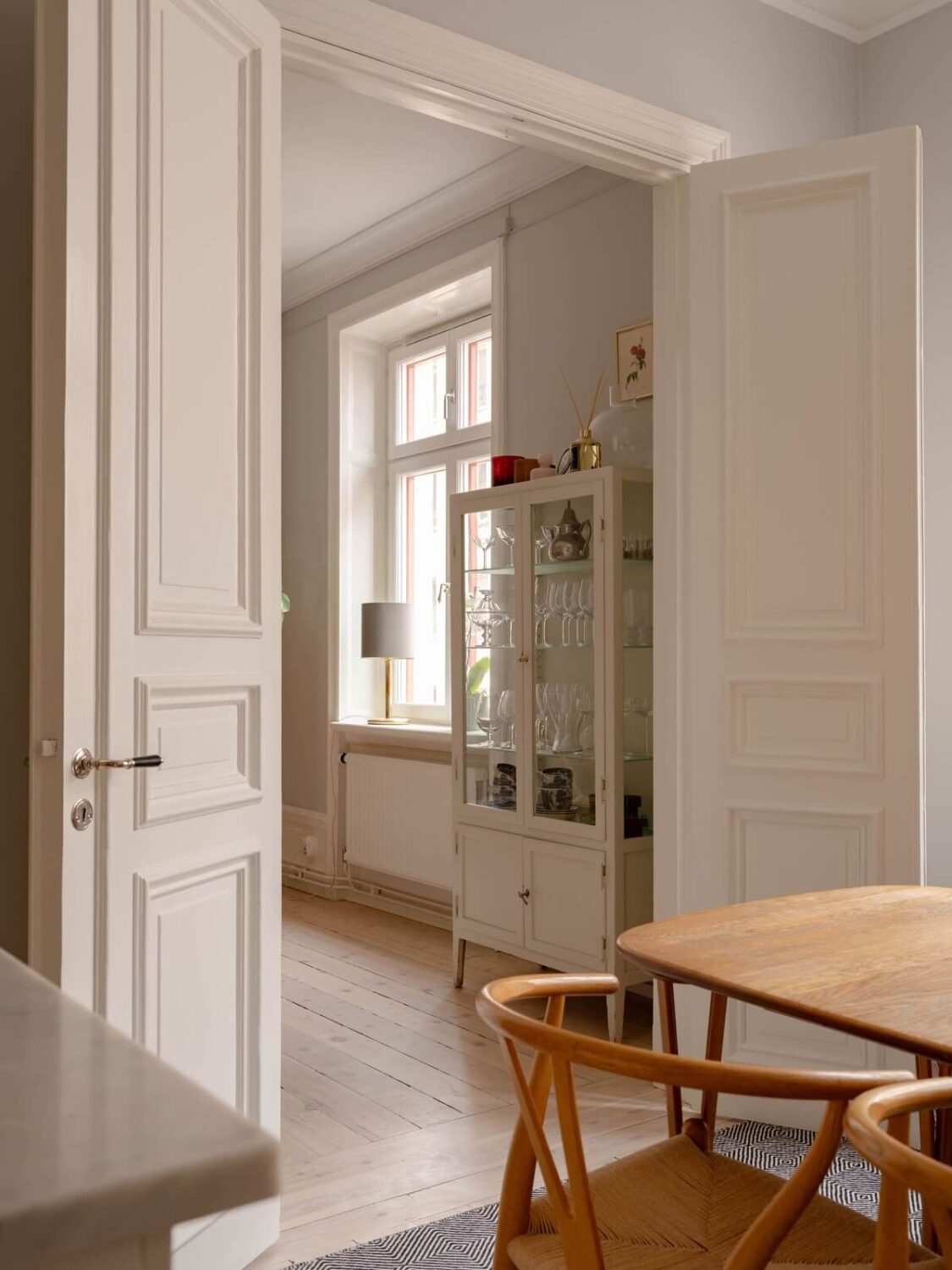 A Spacious Stockholm Apartment with Light Gray Walls 15 double wooden doors