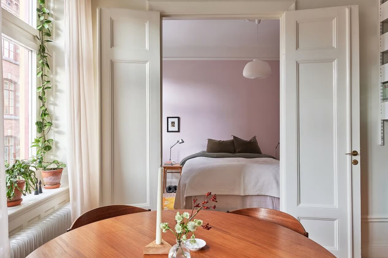 A Light Swedish Apartment with a Yellow Kitchen 10 double wooden doors bedroom